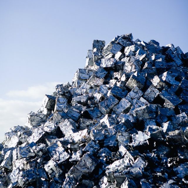 Heap of metal scrap against blue sky
