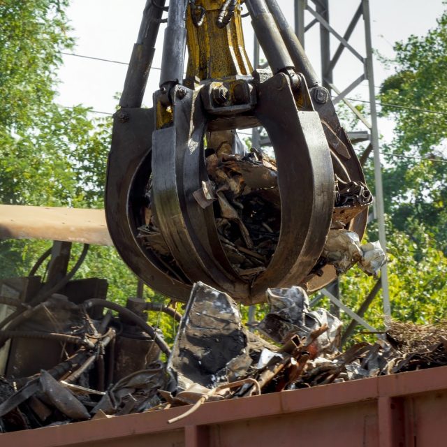 Special hydraulic claw lifting and destroying metal on scrapyard